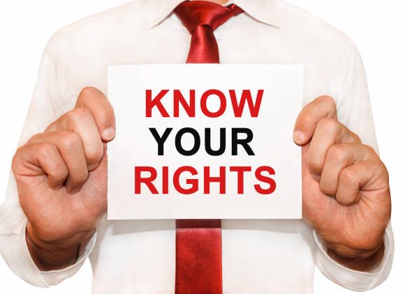Man holding a card with a text Know Your Rights know-your-rights
